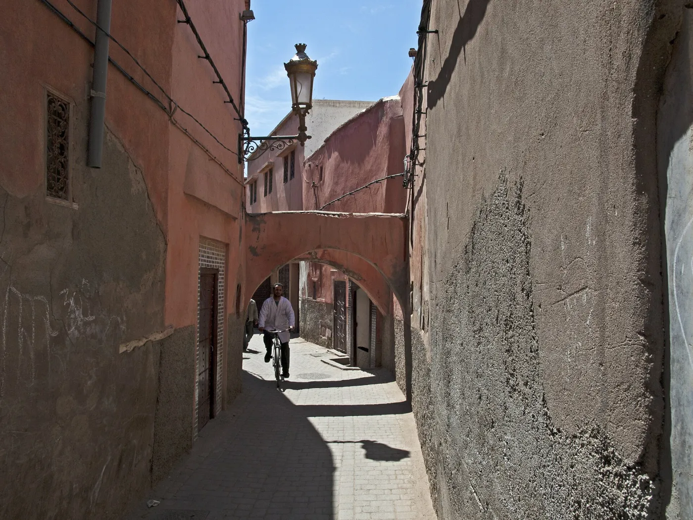 Marrakech medina alley Shaded alley in the Marrakech medina with ochre walls and a wooden door